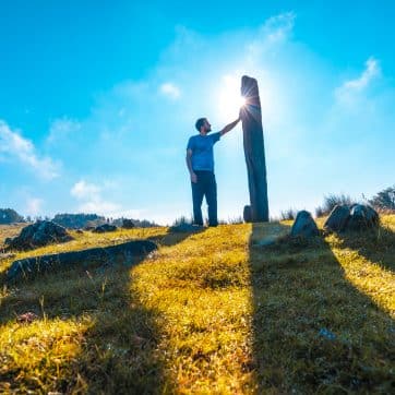 A,Young,Man,Playing,A,Prehistoric,Dolmen,At,Sunrise,Atop